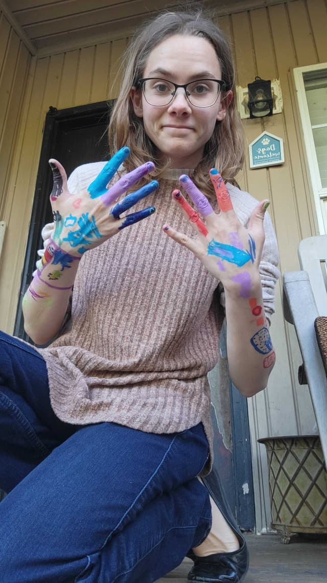 Megan with paint-covered hands after crafts
